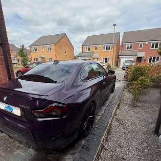 Rear three-quarter view of a detailed purple BMW